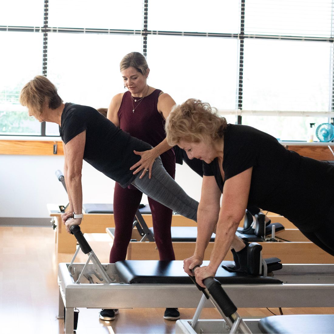 classical-pilates-reformer Karen Wilder, classical Pilates instructor, is teaching a client during a Reformer lesson.